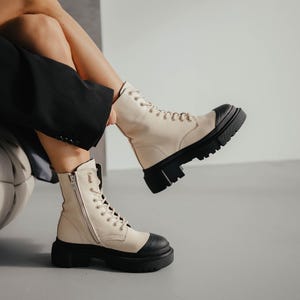 Elegant milk and black leather boots front and side view