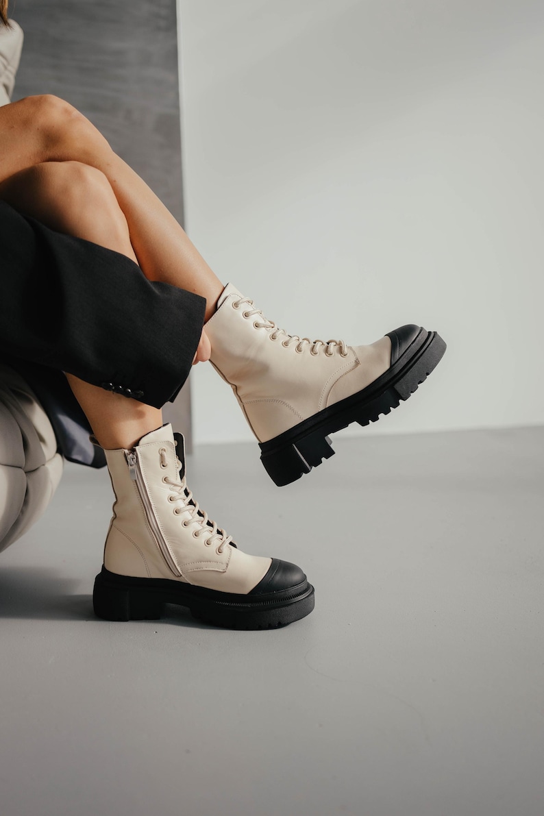 Elegant milk and black leather boots front and side view