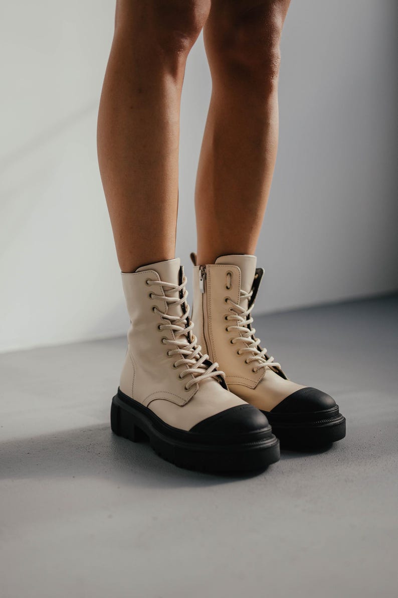 Handmade beige leather boots with black toe detail