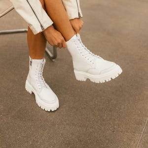 Elegant white leather ankle boots with zipper closure