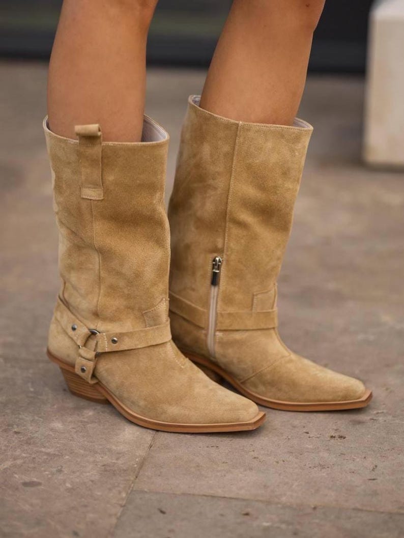Beige suede cowboy boots with side zipper and mid-calf design