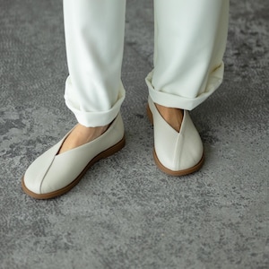 Women’s wide toe leather flats with decorative leather overlay.