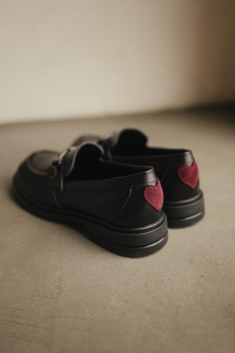 Classic black leather loafers with unique red suede insert decoration