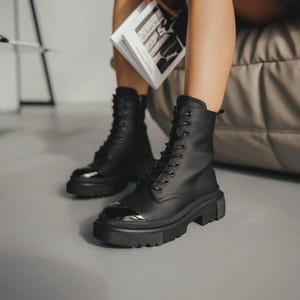 Black matte leather boots with patent leather detail, side zipper, durable lightweight sole, fleece or sheepskin lining