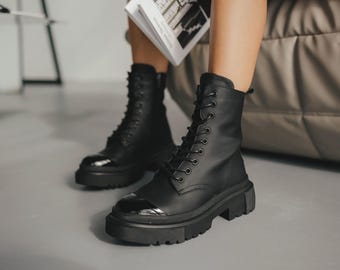 Black matte leather boots with patent leather detail, side zipper, durable lightweight sole, fleece or sheepskin lining