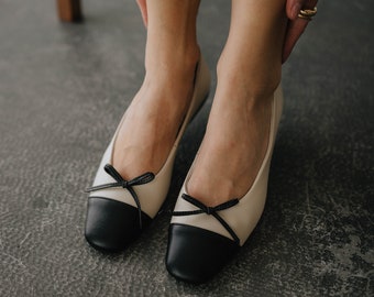 Leather ballet shoes with bow. elegant beige pumps. stylish ballerinas with a round toe in black leather