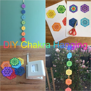 Op de afbeelding: Een doe-het-zelfproject met een chakra-hanger. De afbeelding toont een afgewerkte hanger met kleurrijke geometrische ontwerpen, samen met de materialen en gereedschappen die zijn gebruikt om hem te maken. De tekst "DIY Chakra Hanging" wordt in regenboogkleuren weergegeven.