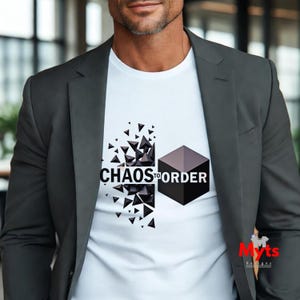 May include: A white t-shirt featuring a graphic design that transitions from scattered black geometric shards on the left to a solid black cube on the right, with the text "CHAOS TO ORDER" printed in black across the centre of the design.