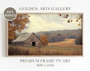 Pode incluir: Uma impressão emoldurada de uma paisagem de outono com um celeiro rústico. A obra de arte apresenta um celeiro de madeira com uma porta aberta, rodeado por árvores com folhagem de outono. O texto "GOLDEN ARTS GALLERY" e "PREMIUM FRAME TV ART" são visíveis.