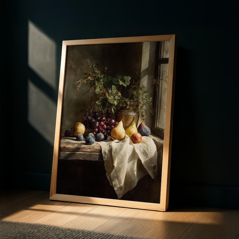 May include: A framed still life painting featuring a rustic wooden table with a white cloth. The table displays a collection of fruits, including grapes, pears, figs, and peaches. A vase with greenery sits in the background, with sunlight streaming through a window.