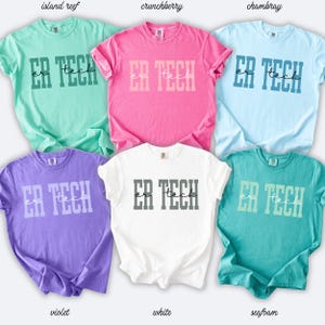 May include: Six short-sleeved t-shirts in shades of green, pink, blue, purple, white, and teal. Each shirt displays the text "ER TECH" in a contrasting colour, with "tech" written in a script font.