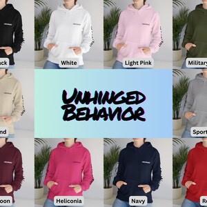 May include: A set of ten hooded sweatshirts in various colors, including black, white, light pink, military green, sand, sport grey, maroon, heliconia, navy, and red. Each sweatshirt features the text "UNHINGED BEHAVIOR" printed on the front and the same text repeated on the sleeves.