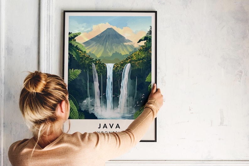 May include: A framed poster featuring a colourful illustration of a waterfall in a lush green jungle setting. The poster depicts a mountain in the background and the text "JAVA INDONESIA" at the bottom.