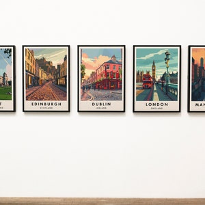 May include: Five framed city skyline prints, each featuring a different city in the United Kingdom. The prints are arranged in a row on a white wall. The cities featured are Belfast, Edinburgh, Dublin, London, and Manchester.