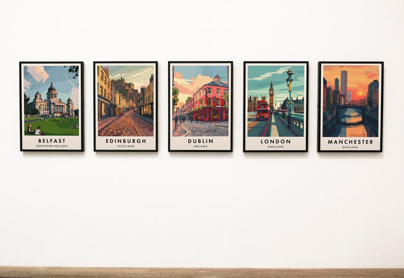 May include: Five framed city skyline prints, each featuring a different city in the United Kingdom. The prints are arranged in a row on a white wall. The cities featured are Belfast, Edinburgh, Dublin, London, and Manchester.