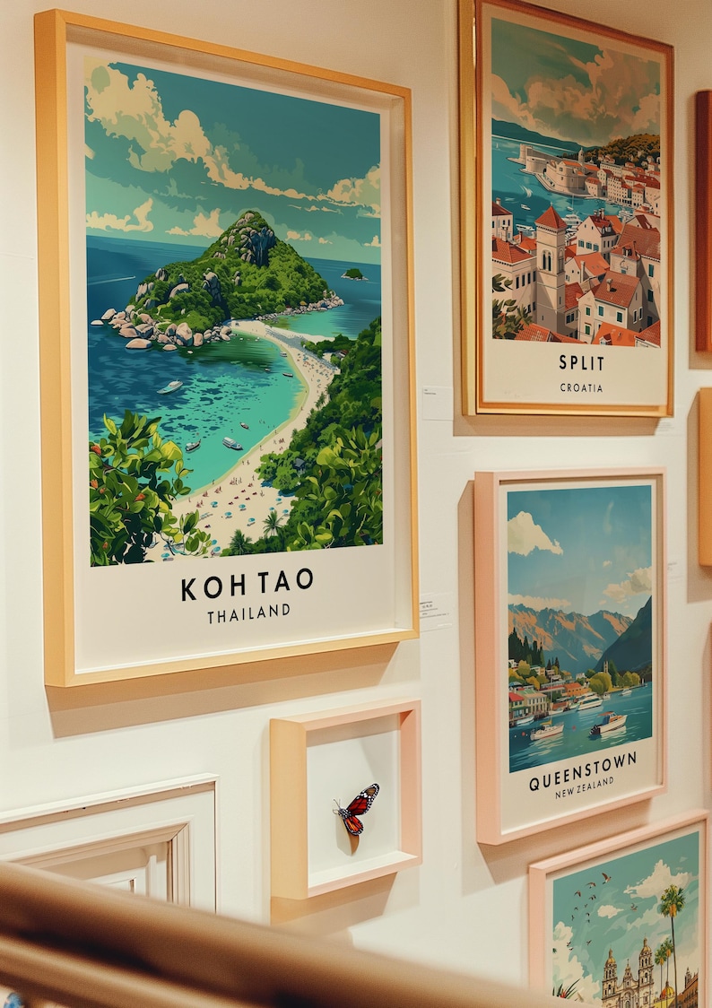May include: A collection of framed travel posters featuring scenic destinations. The posters are in various colors and styles, with a butterfly specimen displayed in a smaller frame.