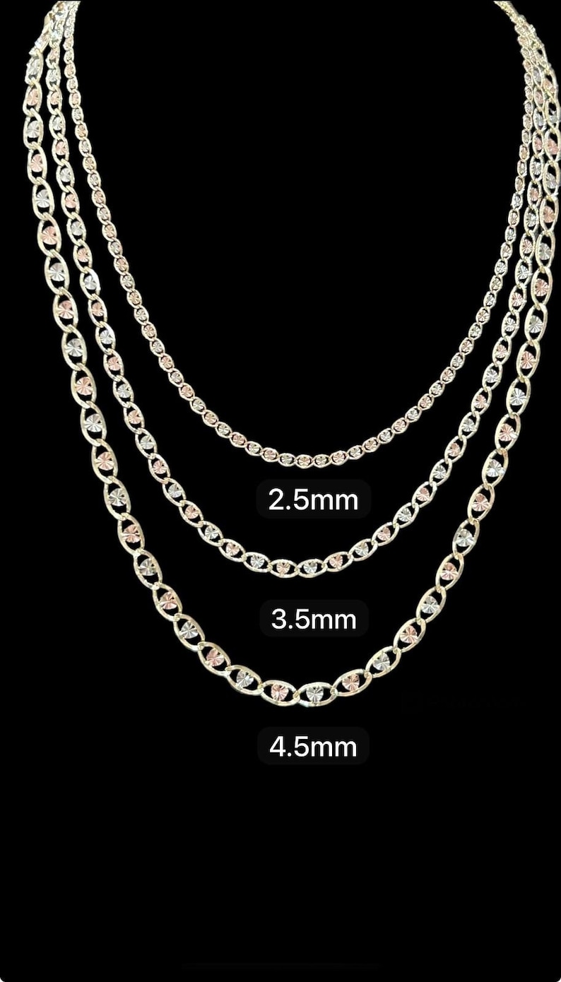 May include: Three gold chains with a heart-shaped design. The chains are 2.5mm, 3.5mm, and 4.5mm wide.