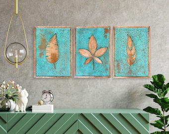 May include: Three square wall art pieces with a turquoise background and gold leaf designs. Each piece features a different leaf design.