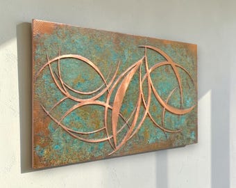 May include: A rectangular wall art piece featuring a textured, oxidized copper surface with a mottled patina of teal, green, and brown. Overlaid on the base are polished, curved copper metal strips forming abstract, intersecting leaf-like shapes.