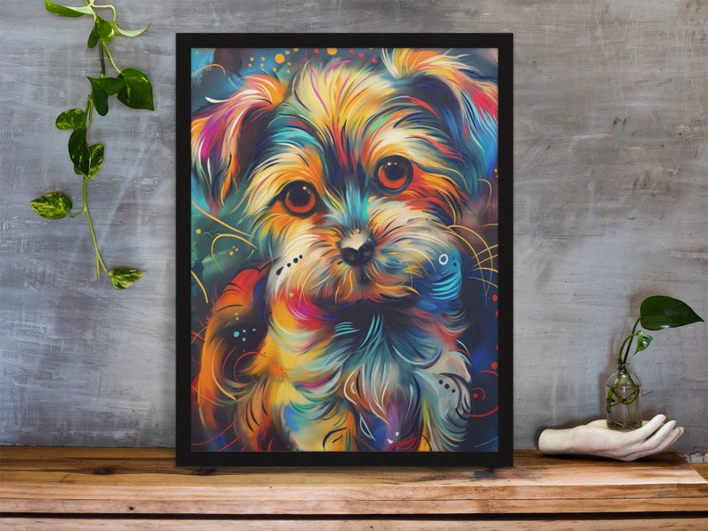 Vibrant art print of a Maltese puppy, depicted with dynamic, multicolored brush strokes, displayed on a desk alongside colorful stationery and houseplants.