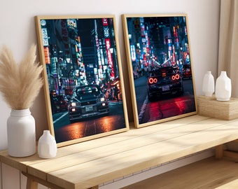 May include: Two framed prints of a black car driving through a brightly lit city street at night. The first print shows the car from the front, while the second print shows the car from the back.