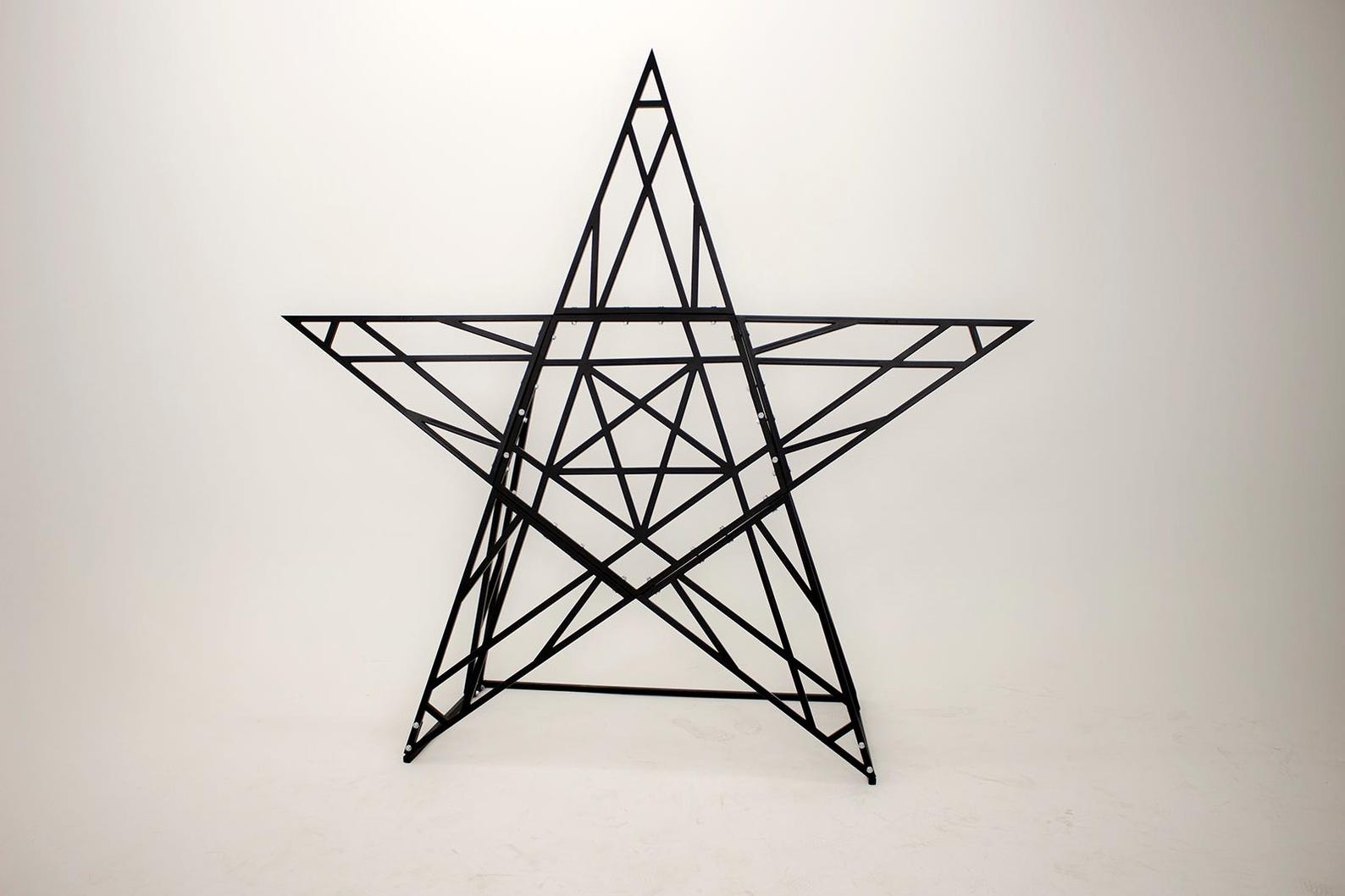 Frontal view of gothic bondage pentagram cross with metal frame, ideal for dungeon scenes or ritualistic bdsm play.