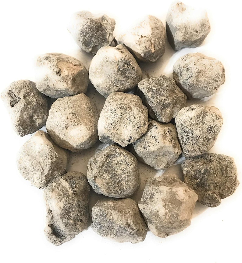 May include: A pile of small, round, gray and white stones. The stones are smooth and have a slightly rough texture.