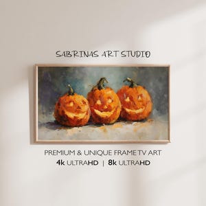 Könnte beinhalten: Ein gerahmtes Kunstwerk mit drei geschnitzten, orangefarbenen Kürbissen mit lächelnden Gesichtern. Die Kürbisse sind in einem impressionistischen Stil mit sichtbaren Pinselstrichen gemalt. Der Text "SABRINAS ART STUDIO" und "PREMIUM & UNIQUE FRAME TV ART" sind oberhalb und unterhalb der Kürbisse zu sehen, darunter "4K ULTRAHD | 8K ULTRAHD".