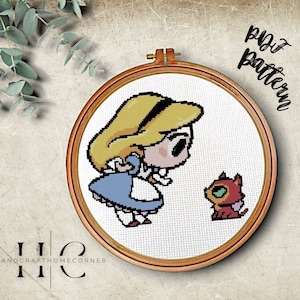 May include: Cross stitch pattern featuring a cartoon Alice in Wonderland with a red cat. The pattern is in a wooden embroidery hoop.