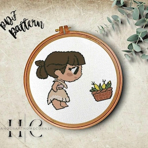 May include: A cross-stitch pattern featuring a cartoon girl with brown hair and a basket of yellow flowers. The pattern is framed in a wooden hoop and includes the text "pufz pattern".
