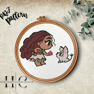 May include: Cross stitch pattern featuring a cartoon illustration of Moana from Disney's Moana, with brown hair, a brown and orange outfit, and a pink flower in her hand. She is looking at a small white pig with black eyes and a pink nose. The pattern is in a wooden embroidery hoop.