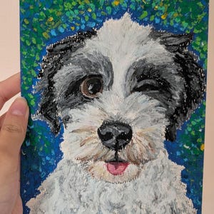 May include: A colorful painting of a dog winking. The dog has black and gray fur around its eyes and ears, with white fur on its face and chest. The background is a mix of blue, green, and yellow paint strokes.