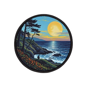 May include: Round patch featuring a coastal scene with a large yellow moon in a blue sky. The image shows a person standing on a cliff, with trees and orange flowers. The patch has a black border.