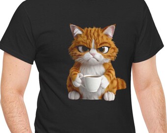 May include: Black t-shirt featuring a grumpy cartoon cat with orange and white fur, holding a white coffee cup. The cat has an annoyed expression. The t-shirt is made of a soft material.