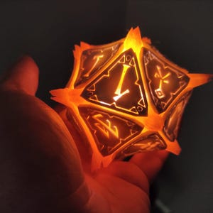 May include: A glowing orange and black 20-sided die with numbers and symbols on each face. The die is lit from within, casting a warm orange glow.
