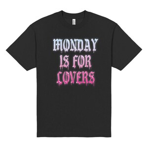 May include: Black t-shirt with the text "MONDAY IS FOR LOVERS" in a dripping, gradient font. The text transitions from light blue to pink. A casual, everyday wear tee.