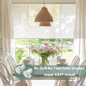 May include: A dining room scene with a rustic wooden table set for a meal. A large floral arrangement of white and pink flowers sits in a glass vase. The text "No Drill No Tool Solar Shades Super EASY Install" is visible.