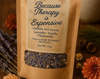 May include: A brown paper bag of simmer pot blend with a clear window, featuring the text "Because Therapy is Expensive." The blend includes lavender, vanilla, and chamomile. The net weight is 2 oz. Decorative flowers and lavender sprigs surround the bag.