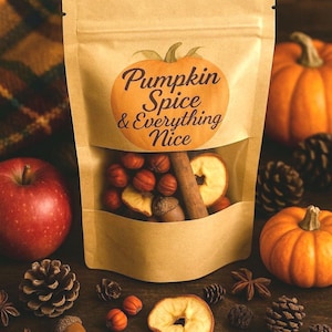 May include: A kraft paper bag with a clear window, labeled "Pumpkin Spice & Everything Nice," filled with spices, dried apple slices, and cinnamon sticks. The image includes pumpkins, pine cones, and an apple.