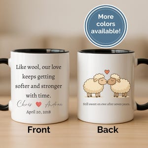 May include: White ceramic mug with a black handle and rim. The front of the mug has text that reads "Like wool, our love keeps getting softer and stronger with time." The back of the mug has a cartoon of two sheep kissing.
