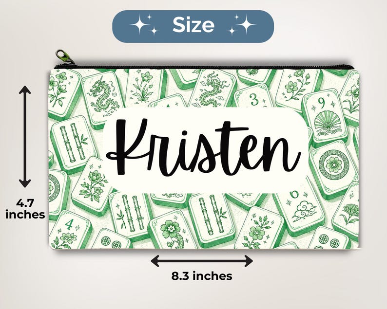May include: A rectangular zippered pouch featuring a green and white pattern of mahjong tiles with various symbols, including dragons, bamboo, and flowers. The center displays the name Kristen in black script. It measures 4.7 inches by 8.3 inches.