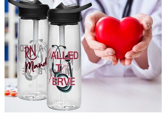 May include: Two clear plastic water bottles with black lids and a straw. The bottles have a design that says "RN Called to Serve" with a stethoscope graphic. The bottles are on a white surface.