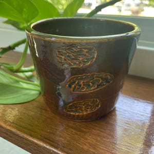 Brown with green accents handleless handmade mug