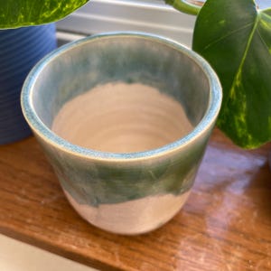 Muted green and white handleless handmade mug