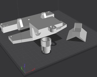 May include: A 3D printed model of a mechanical part with a gear, a base, and a separate piece. The model is printed in a light gray color.