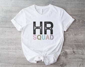 May include: White t-shirt with black text that says "HR Squad" in a distressed font. The word "HR" is in all caps and the word "Squad" is in lowercase letters with each letter in a different pastel color.