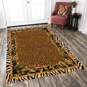 May include: A brown and tan area rug with a leopard print pattern surrounded by a black and white zebra print border. The rug has a floral design with green leaves and pink flowers.