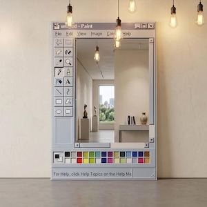 May include: A rectangular mirror designed to resemble the classic Windows Paint application interface. The frame is light gray with a toolbar on the left and a color palette at the bottom. The mirror reflects a room with art and a city view. Text on the frame reads "und - Paint".