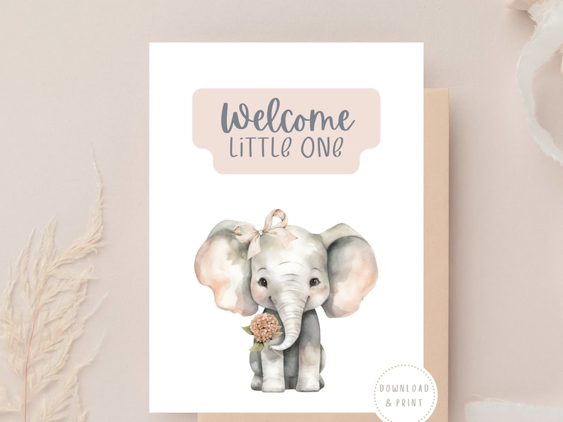 May include: A printable welcome sign with a watercolor illustration of a baby elephant holding a pink flower. The sign has the text "Welcome Little One" in a light pink rectangle.