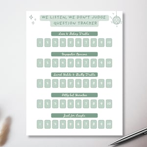 May include: A white question tracker with green text and boxes. The text reads "We Listen, We Don't Judge Question Tracker." Categories include "Love & Dating Truths" and "Unpopular Opinions." A pen rests on the bottom right.